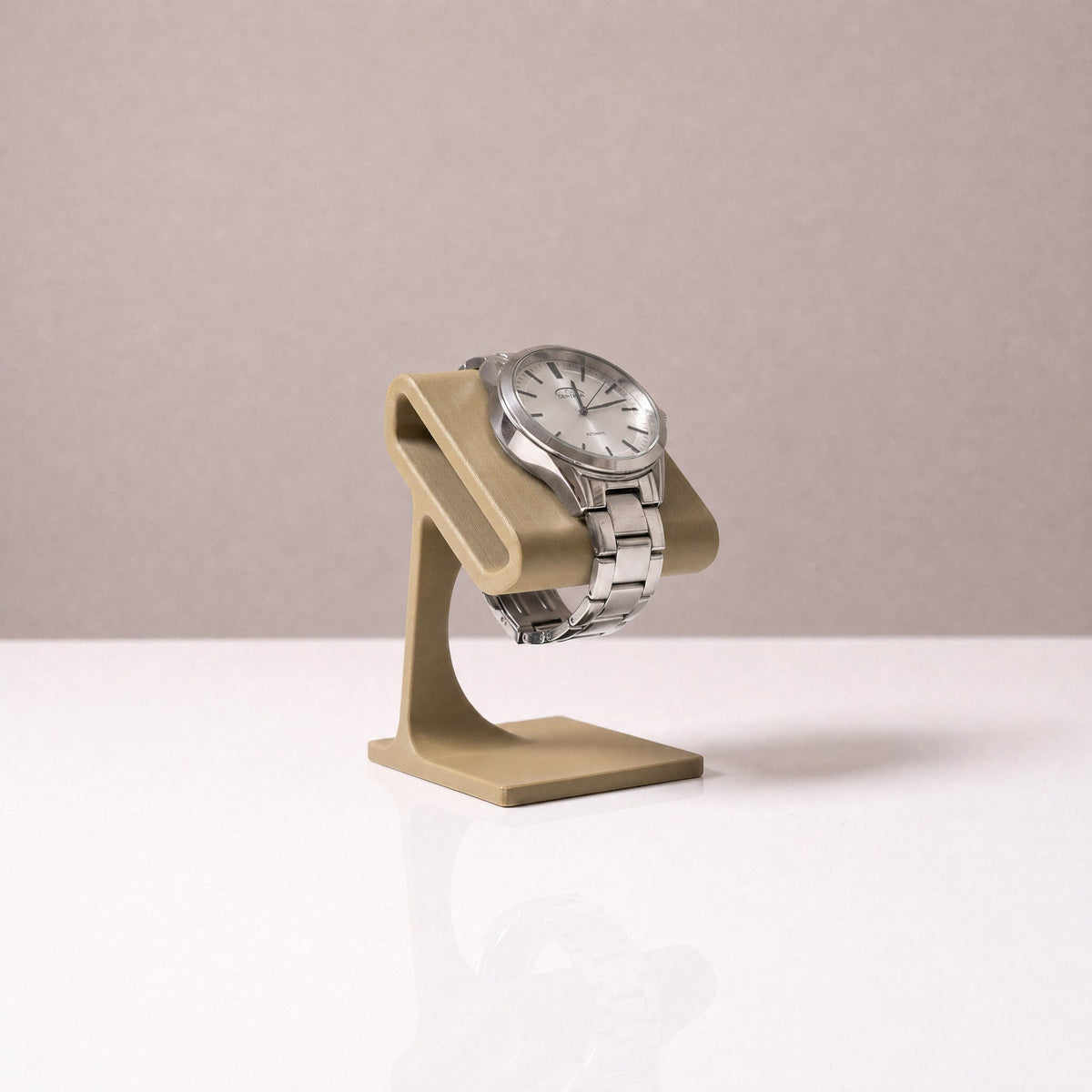 Solitaire watch stand in Olive holding a steel watch